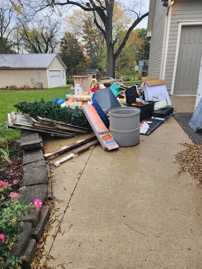 Dumpster being loaded with debris for Roofing Dumpster Rental in West Windsor